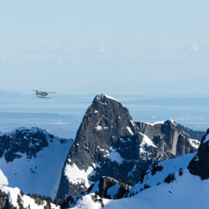 Seaplane flying above mountains.