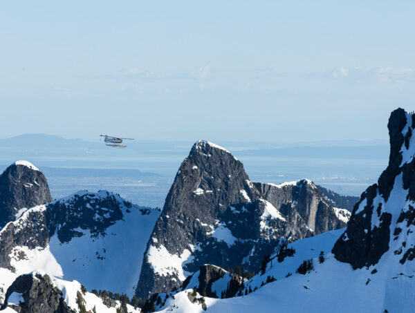 Seaplane flying above mountains.